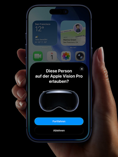 Eine Hand h?lt ein iPhone; das iPhone Display zeigt ein Fenster mit der Meldung ?Diese Person auf der Apple Vision Pro erlauben“ und den Schaltfl?chen ?Fortfahren“ und ?Ablehnen“