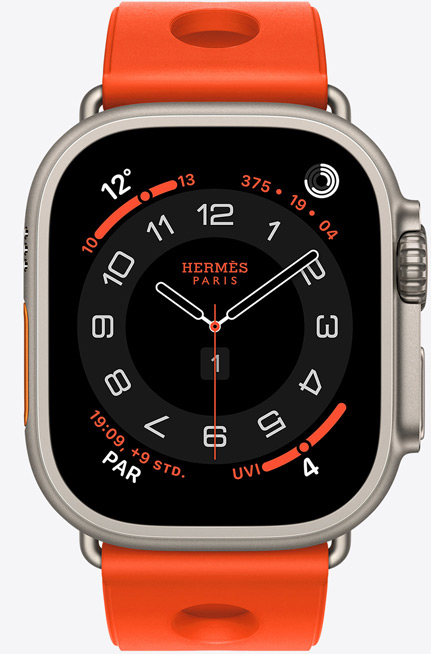 Apple Watch Hermès Ultra 3, analoges Zifferblatt Circulaire, (Stunden-, Minuten- und Sekundenzeiger, Komplikationen: Wetter, Aktivit?tsringe, Paris Zeit und UV Index), Titangeh?use, Farbe Natur, rechte Seite, Digital Crown, erh?hte Seitentaste, kombiniert mit Scub’H Diving Armband, Farbe Orange Néon (leuchtendes Orange), geformtes Gummi, kreisf?rmige Aussparungen in der Mitte