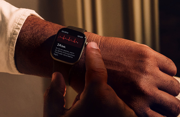 Eine Person h?lt die Digital Crown auf der Apple Watch Series 11 gedrückt, um ihre Herzgesundheit mit der EKG App zu messen