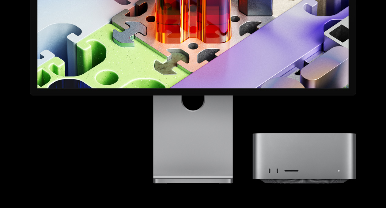 Studio Display XDR ligado ao Mac Studio que se encontra por baixo do monitor: o Studio Display XDR tem um papel de parede em forma de puzzle tridimensional