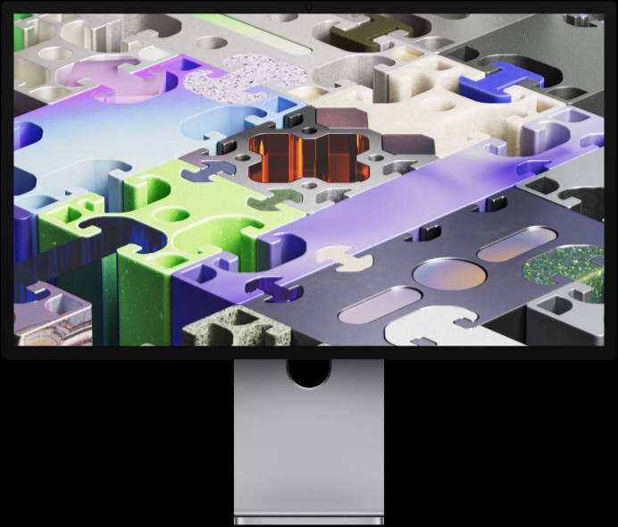 Vista frontal do Studio Display XDR com papel de parede em forma de puzzle tridimensional