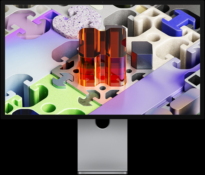 Vista frontal do Studio Display XDR com papel de parede em forma de puzzle tridimensional